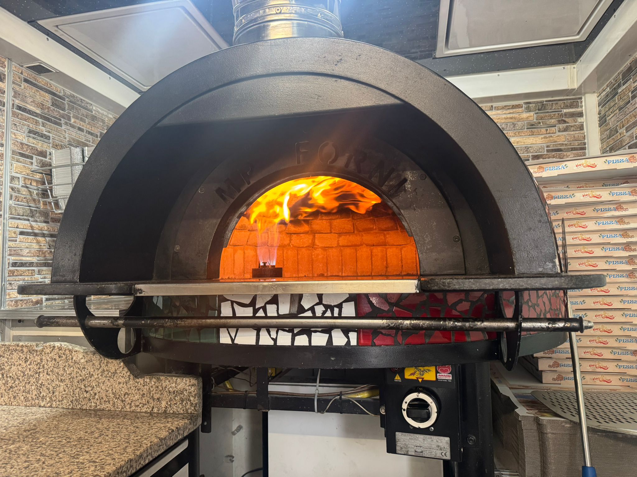 The Flow's stone pizza oven roaring at full heat